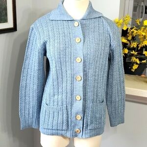 Beautiful hand Knit sweater. Size large. Blue with wooden buttons and 2 pockets.